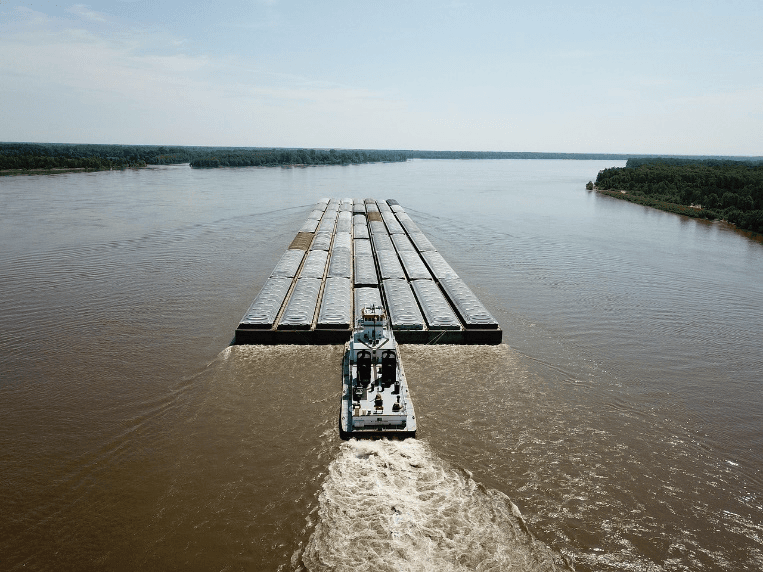 Photo of a barge being pushed along the Mississippi River near Alton, Illinois.